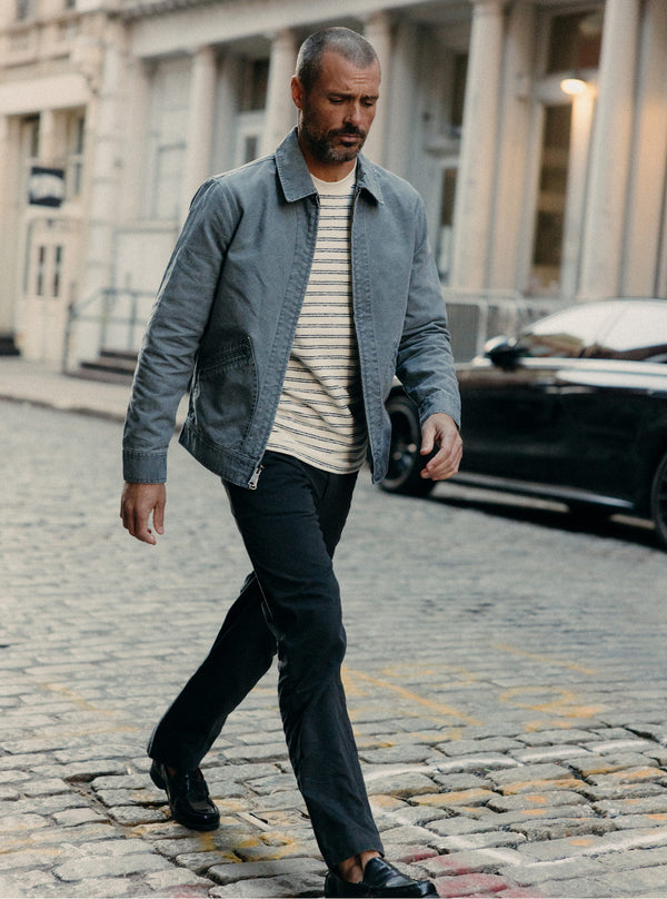 Model walking on cobblestone streets in the city