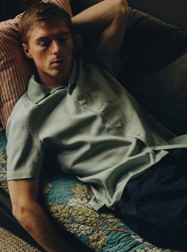 Model lying on a sofa, wearing the Hawthorne Shirt