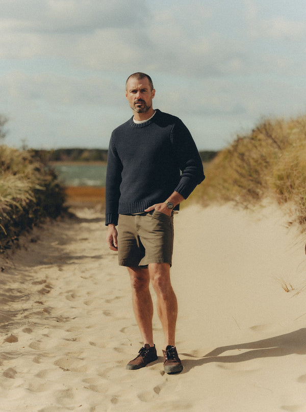 Model wearing the Topsail Sweater on the beach