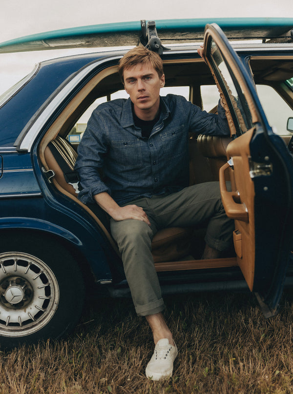 Model sitting in a vintage Mercedes, with the door open