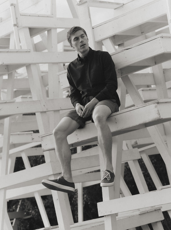 Model sitting on a lifeguard tower