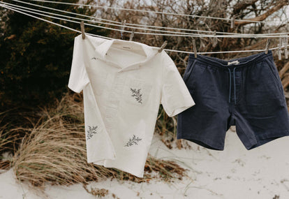 The Conrad Shirt in Seaside Embroidery and shorts on a clothesline