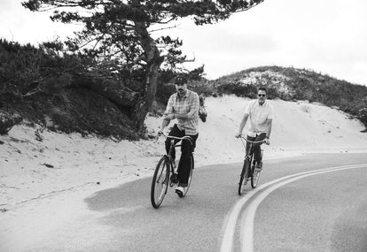 Two guys riding bikes in Cape Cod