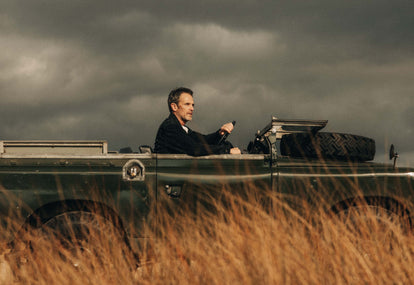 Model driving in a vintage jeep