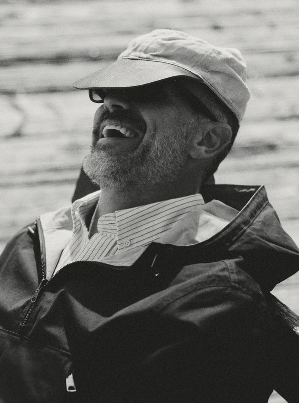 Model laughing, wearing The Squall Anorak