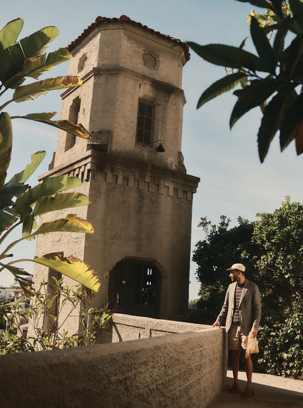 Model standing by a spanish revival tower in Los Angeles