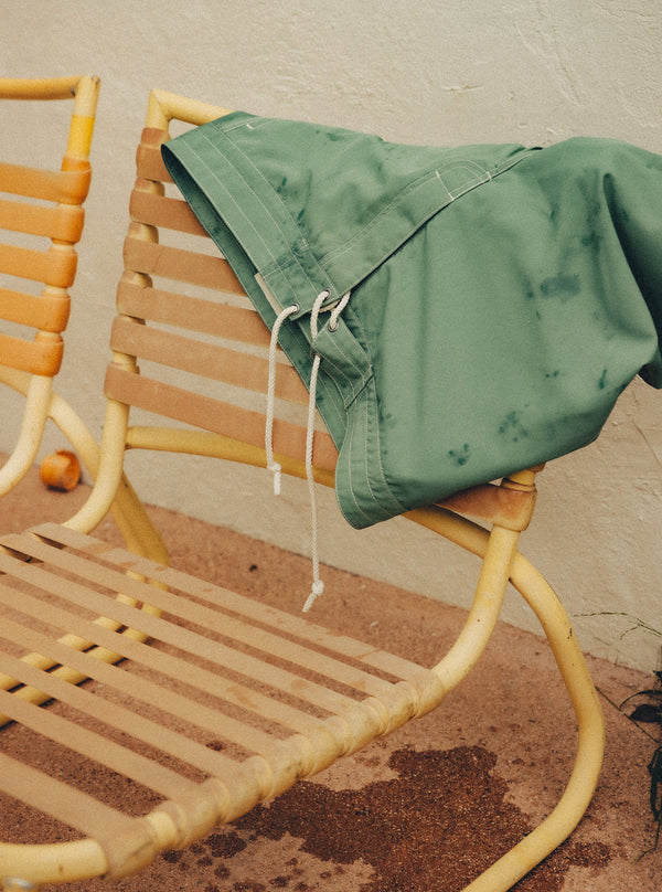 The Drift Board Short draped over a yellow chair