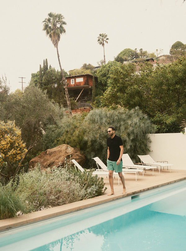 Model walking by the pool in the Drift Board Short