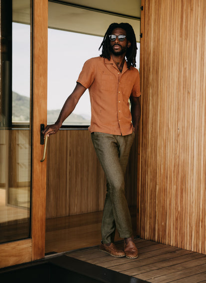 Model standing by the doorframe in The Conrad Shirt and The Easy Pant