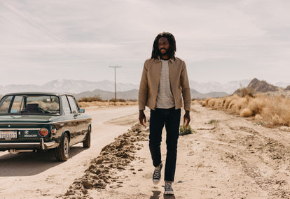 Model walking in the desert, wearing The Shifter Jacket