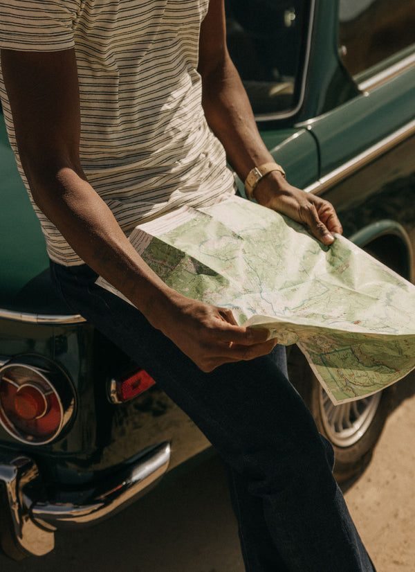 Model looking at a map of the desert