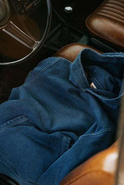 The Apres Hoodie in Washed Indigo Terry on the seat of a car