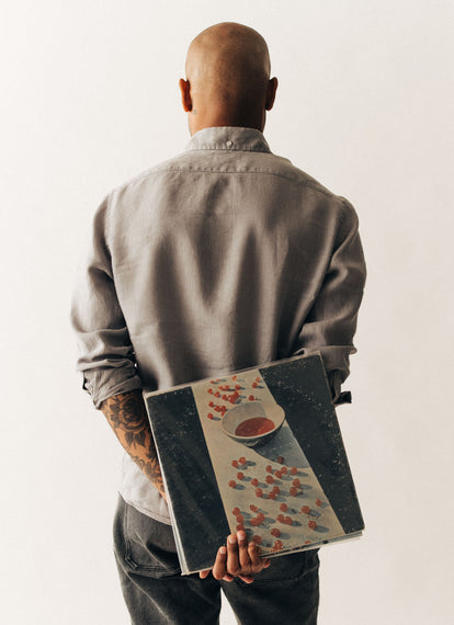 Model wearing The Jack in Overcast Linen, holding a record