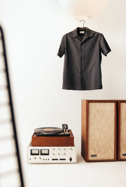 The Davis Shirt in Kelp Stripe, hanging in the studio