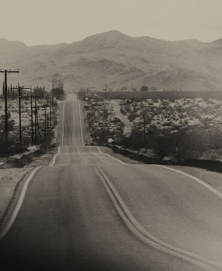 Road stretching through the desert, by Taylor Stitch