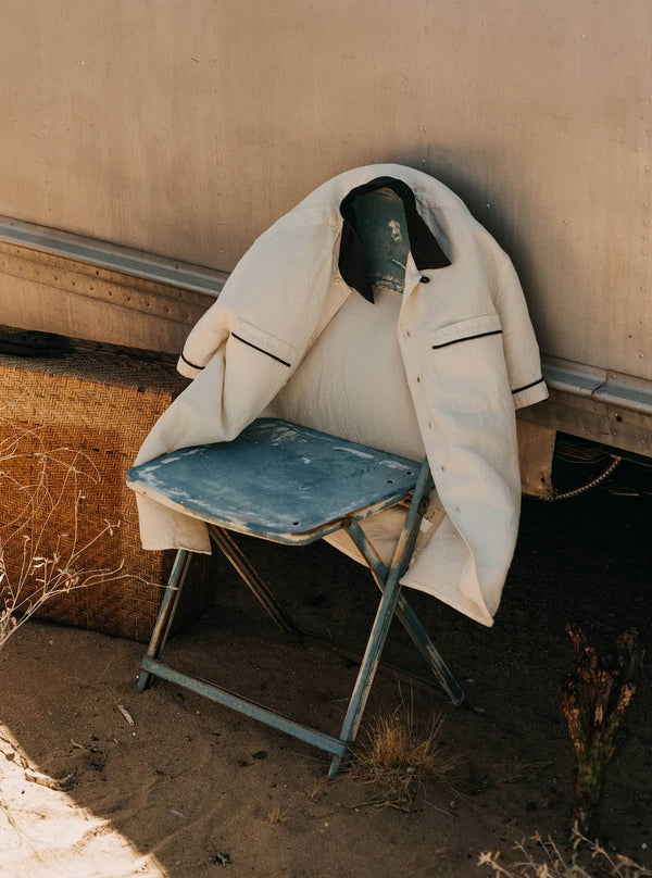 The Weber Shirt in Vintage White draped over a chair