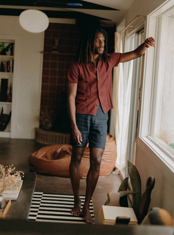 Model wearing The Button Down Polo in Dried Cherry Stripe with The Easy Shorts in Navy Linen