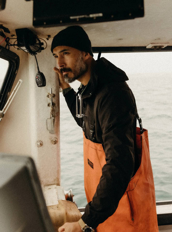 Model in a boat, wearing The Ridgeline Jacket