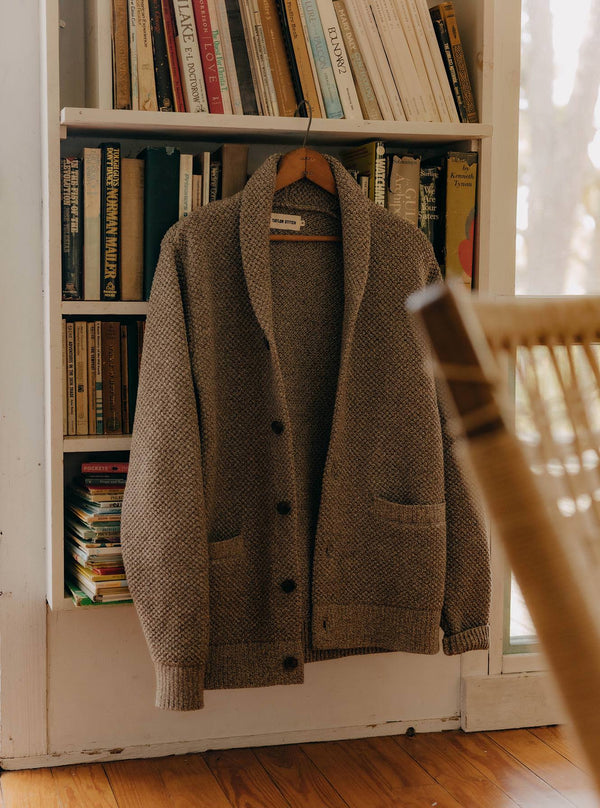 The Crawford Sweater in Coffee Twist hanging on a bookcase