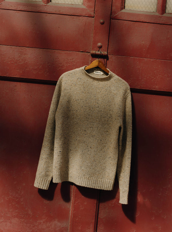 The Seafarer Sweater in Natural Donegal hanging on a wall