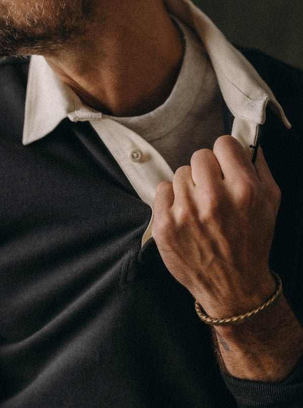 Model pulling the collar of The Rugby Shirt