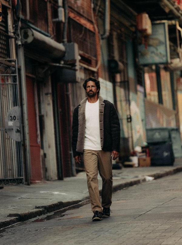 Model walking though chinatown in the Coleman Jacket