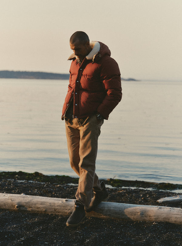 Model walking on the beach in the Down Sweater Jacket