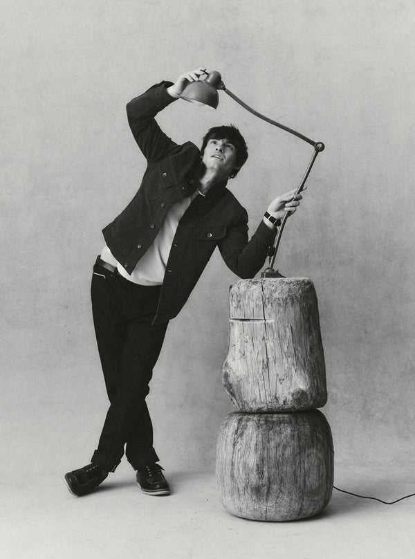Model playing with a lamp, wearing The Long Haul Jacket