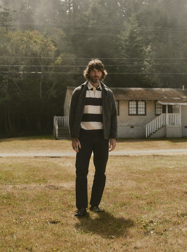 Model standing in a field, wearing The Rugby Shirt