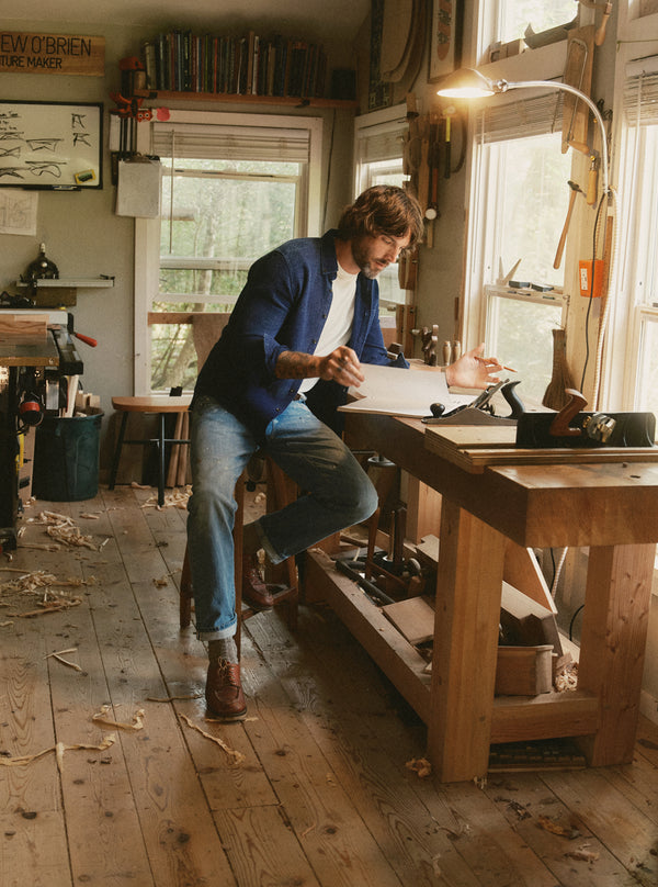 Man sitting by his workshop table