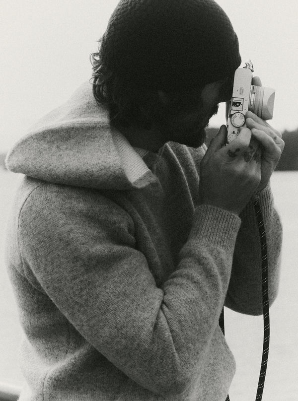 Man taking a photo in the Haven Sweater Hoodie