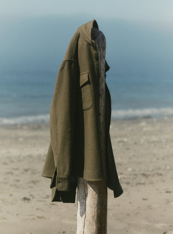The Maritime Shirt Jacket draped on a wooden beam