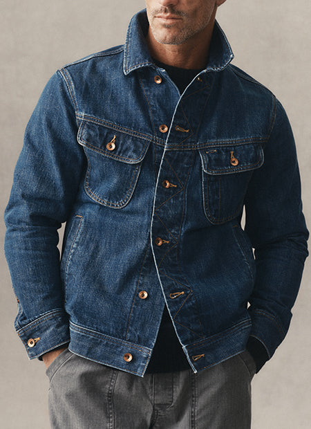 fit model posing in The Long Haul Jacket in Mid Wash, by Taylor Stitch