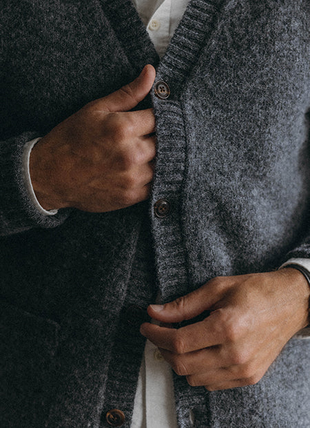fit model buttoning up The Eastmoor Cardigan, by Taylor Stitch