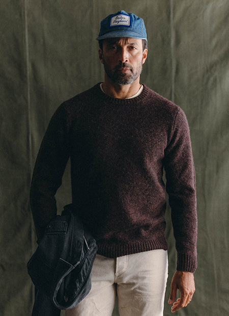 fit model posing in The Eastmoor Sweater in Port, by Taylor Stitch