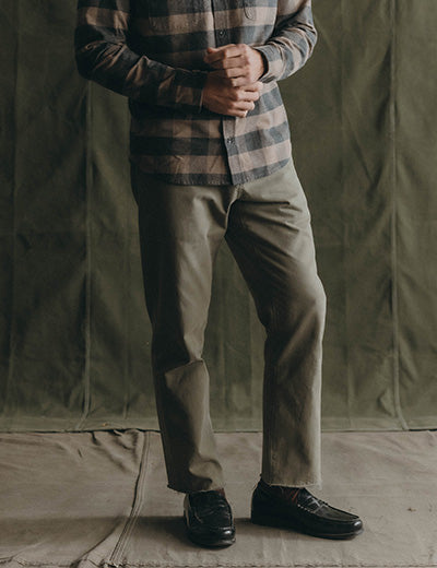fit model posing in The Democratic Foundation Pant in Smoked Olive, by Taylor Stitch