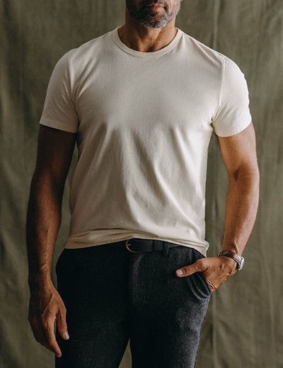 fit model posing in The Cotton Hemp Tee in Natural, by Taylor Stitch