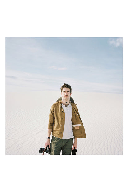 A photographer in the desert dunes