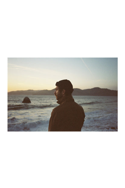 A film photo of a man at the ocean