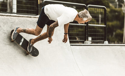 Our guy skating a half-pipe in shorts and tee.