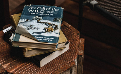 Stack of books, topped with 'Call of the Wild' by Jack London.