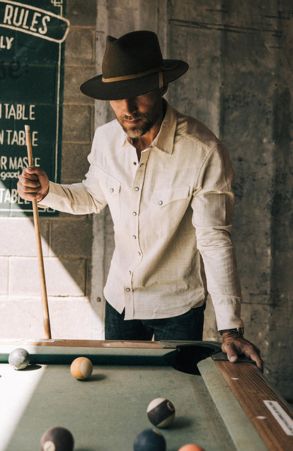 Our guy playing pool in a natural corded western shirt and TS x Stetson hat.