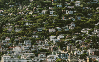 A steep hillside suburb, shot from a distance.