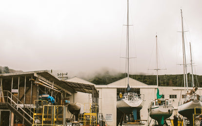 A working marina scene with several dry-docked yachts.