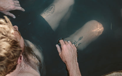 Overhead shot looking down on a guy sitting in a hot tub.