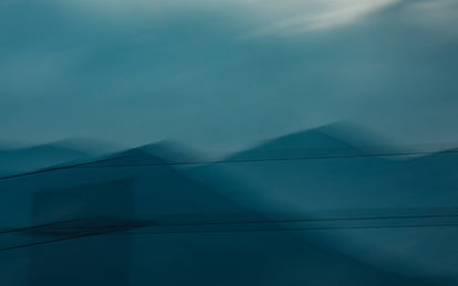 Abstract blue image of blurred mountains.