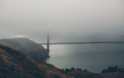 Moody shot of the Golden Gate bridge, surrounded in fog.