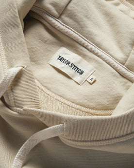 material shot of the label and drawstring on The Fillmore Hoodie in Natural, Knits by Taylor Stitch