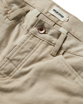 material shot of the button opening on The Chore Pant in Sand Boss Duck, Bottoms by Taylor Stitch