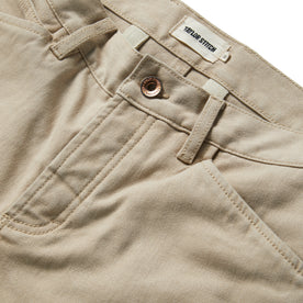 material shot of the button opening on The Chore Pant in Sand Boss Duck